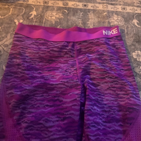 These stylish Nike capri leggings for women’s feature a vibrant purple design. - Picture 3 of 6